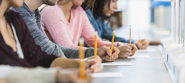 Cropped view of group of teenagers taking a test